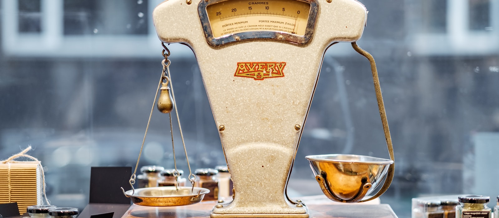 A vintage balance scale with two differently shaped weighing pans