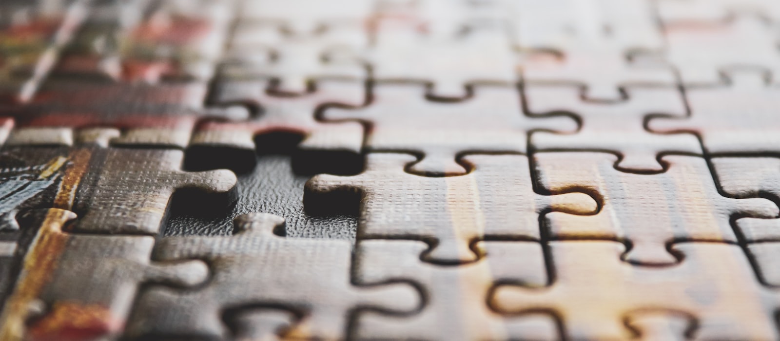 An assembled jigsaw puzzle with a single piece still missing