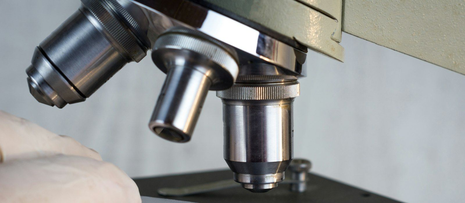 Close-up of microscope objective lenses above a slide stage