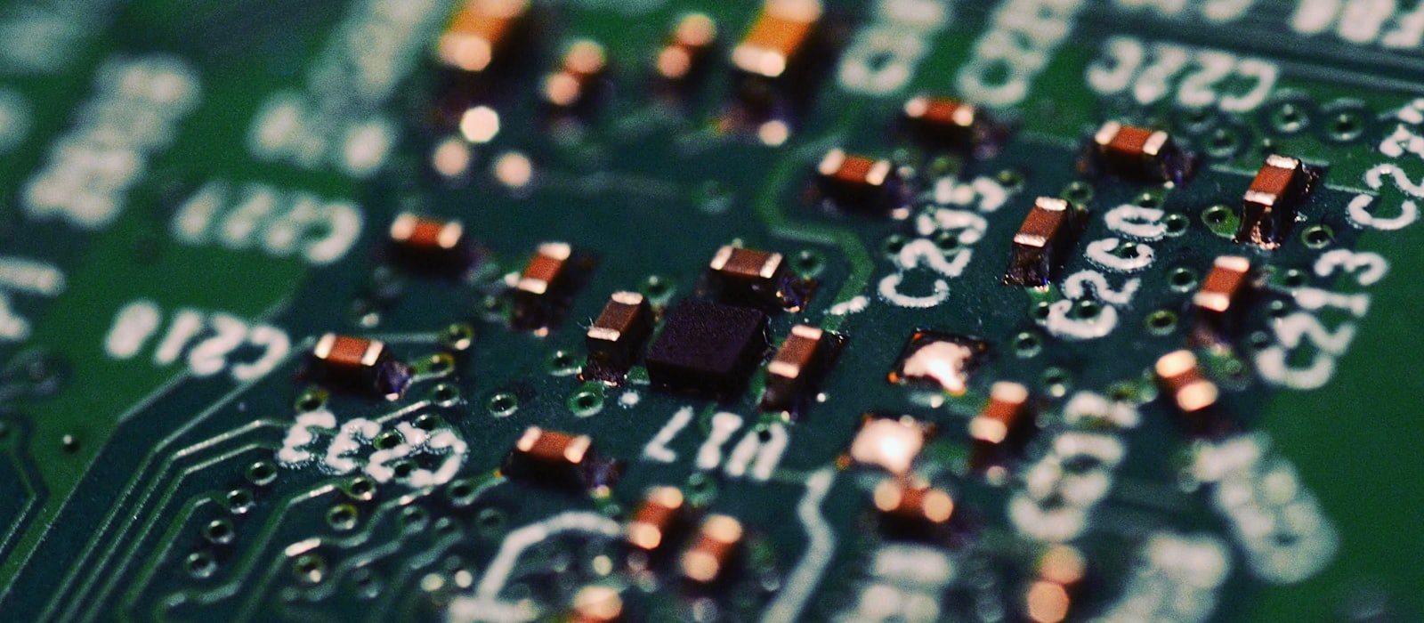 A green circuit board photographed close up, components and reference codes visible