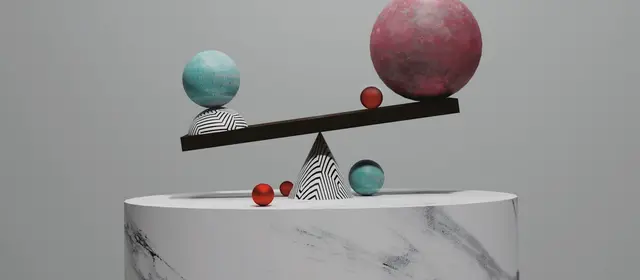 A balance beam on a marble plinth tipped by spheres of different sizes