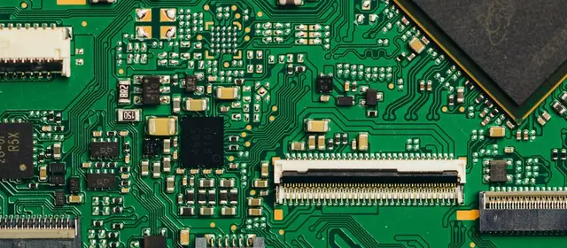 Close-up of a green circuit board with chips and connectors