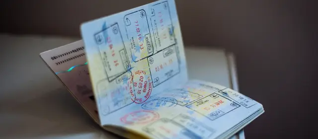 An open passport showing pages covered in entry and exit stamps