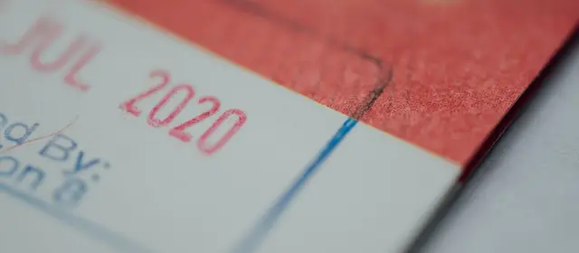 A close-up of a red date stamp inked onto an official document