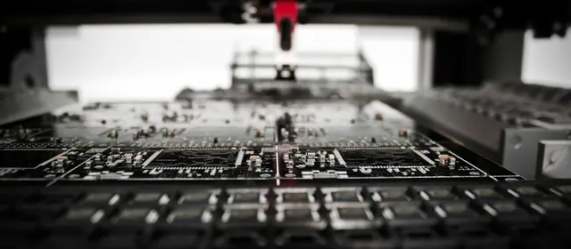 A robotic placement machine working above a printed circuit board